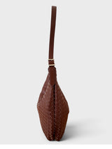 A brown woven leather shoulder bag with a single strap and gold-tone hardware, shown from a side profile view against a light gray background.