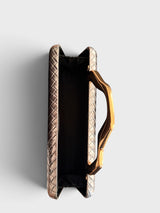 Vegan leather evening clutch shown opened with interior with black polyester lining. 
