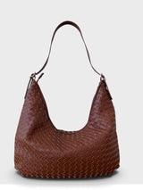 A brown woven leather hobo shoulder bag with a single shoulder strap, shown against a light gray background.